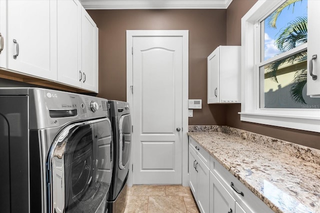 laundry room with cabinets, washer and clothes dryer, and crown molding