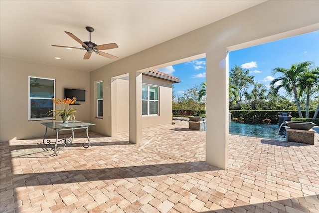 view of patio / terrace with pool water feature and ceiling fan