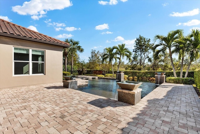 view of pool featuring a patio area and a jacuzzi