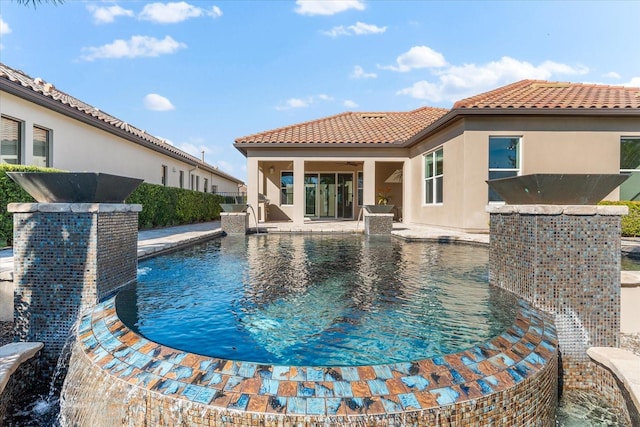 view of pool featuring pool water feature and a patio area