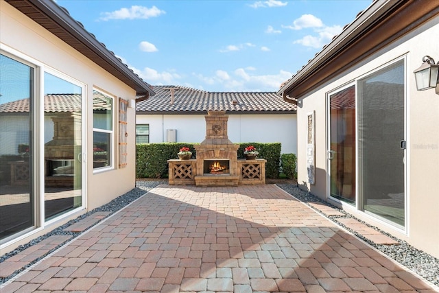 view of patio / terrace with an outdoor stone fireplace