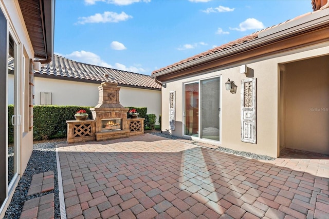 view of patio featuring an outdoor stone fireplace