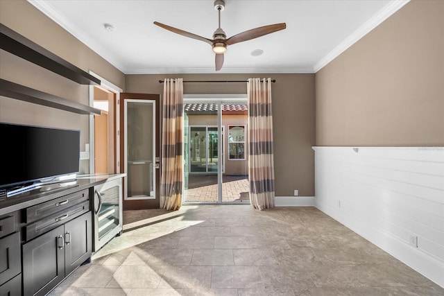 unfurnished living room with ceiling fan and crown molding