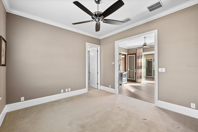 empty room with ceiling fan, light colored carpet, and ornamental molding