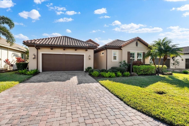 mediterranean / spanish home with a garage and a front lawn