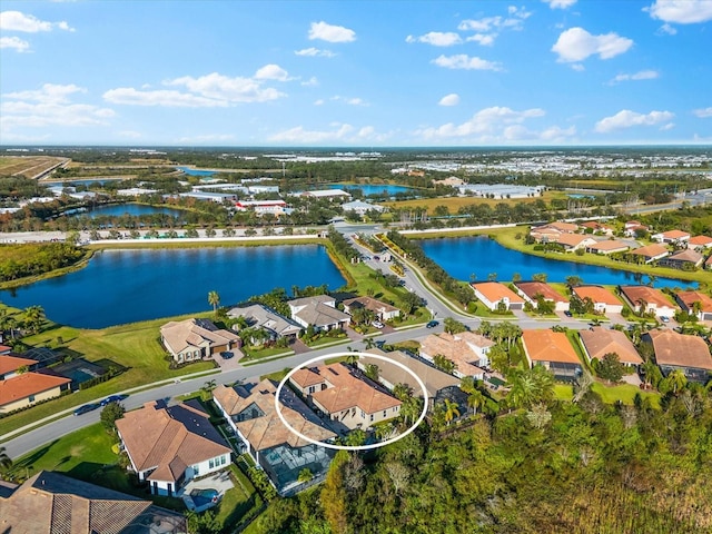 birds eye view of property with a water view