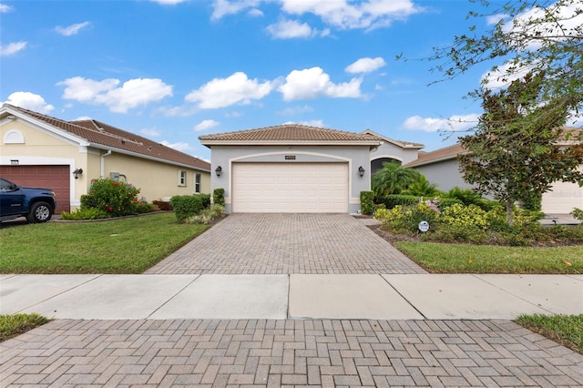 view of front of house featuring a garage and a front lawn