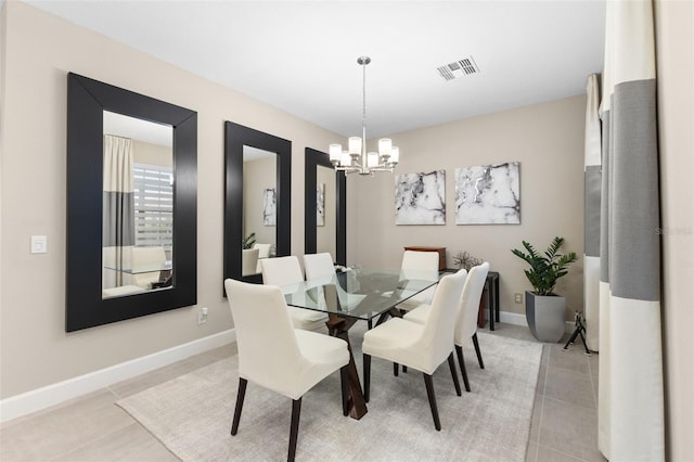 tiled dining space featuring an inviting chandelier