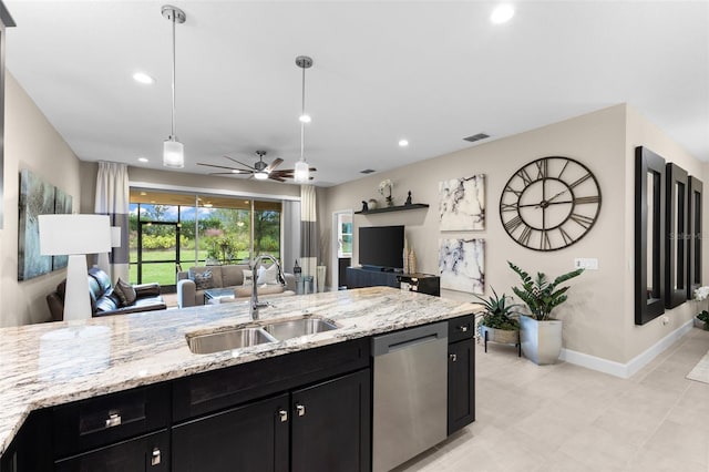 kitchen featuring pendant lighting, sink, light stone counters, and dishwasher