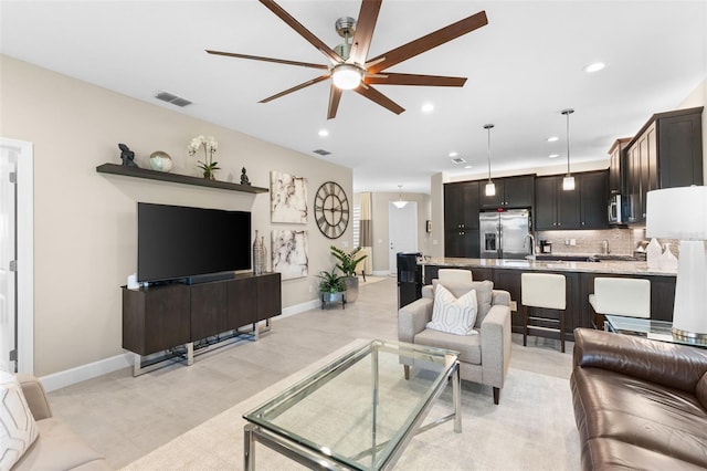 living room with sink and ceiling fan