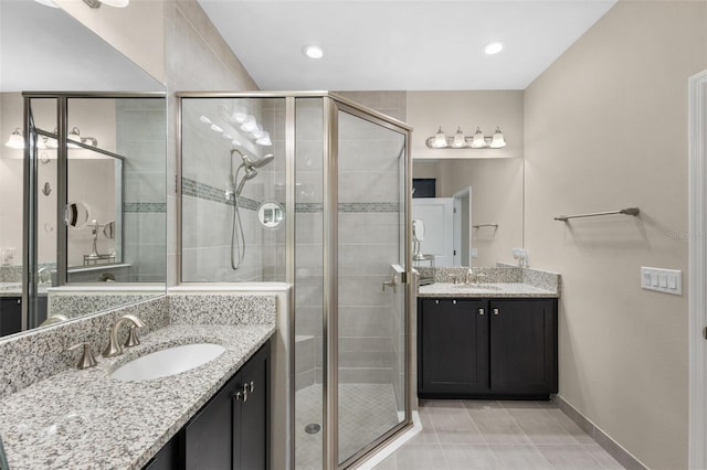 bathroom with tile patterned flooring, vanity, and a shower with door