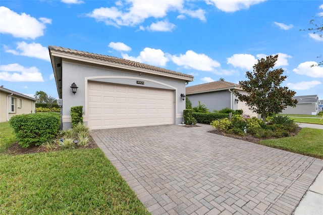 view of front of home with a garage and a front yard