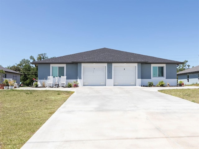 view of front of home featuring a porch, a front yard, and a garage