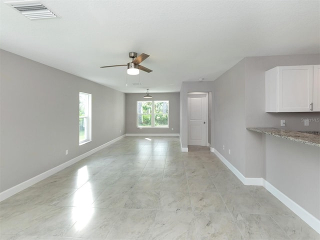 unfurnished living room featuring ceiling fan