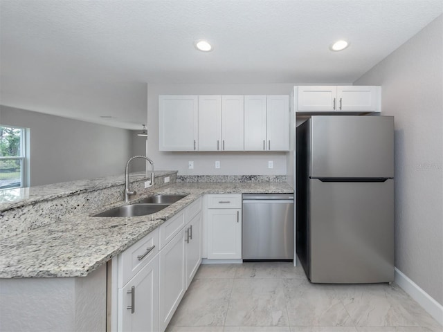 kitchen featuring sink, white cabinets, and stainless steel appliances