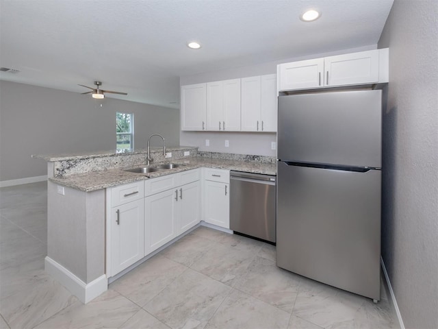 kitchen featuring white cabinetry, sink, ceiling fan, kitchen peninsula, and appliances with stainless steel finishes