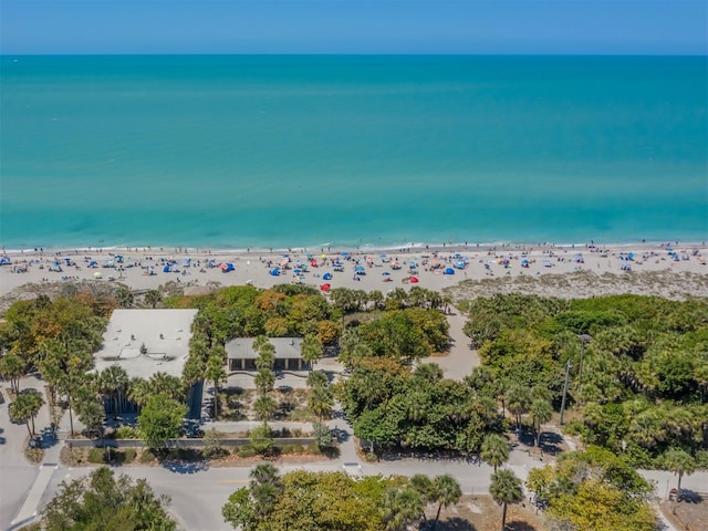 drone / aerial view with a beach view and a water view