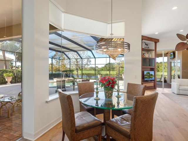 dining area featuring ceiling fan and light wood-type flooring