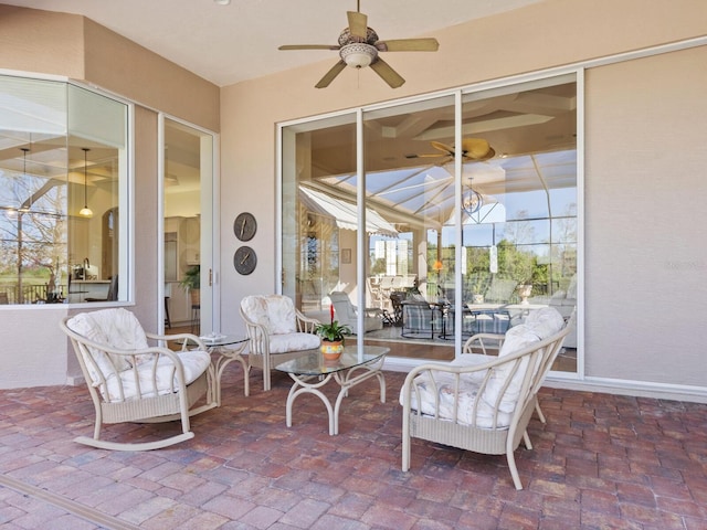 view of patio / terrace featuring ceiling fan and a lanai