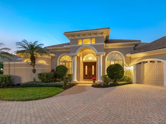 mediterranean / spanish house featuring french doors and a garage