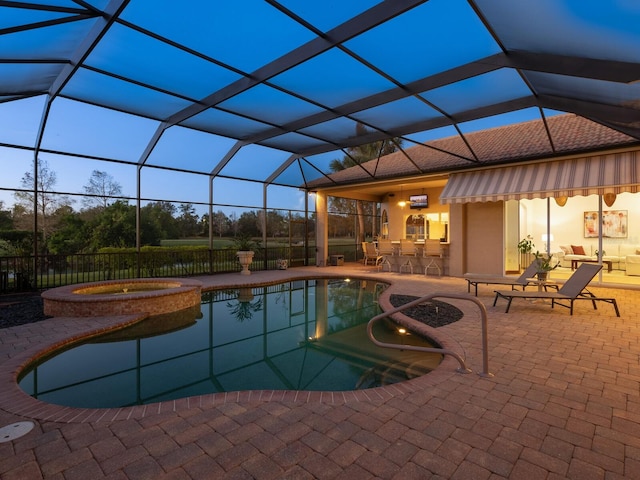 view of swimming pool featuring glass enclosure, an in ground hot tub, an outdoor bar, and a patio