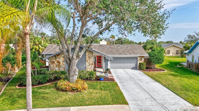 ranch-style home featuring a garage and a front lawn