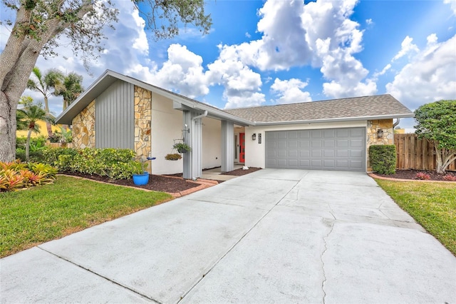 single story home with a garage and a front lawn