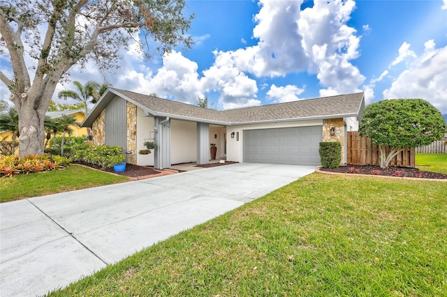 single story home with a garage and a front yard