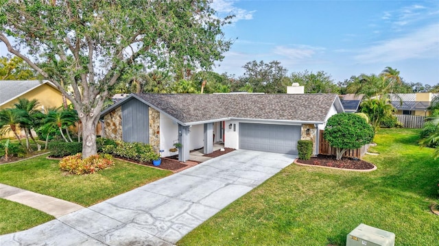 single story home featuring a front yard and a garage