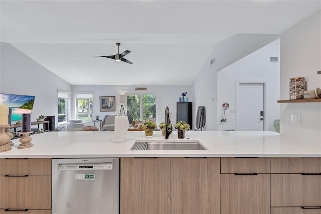 kitchen featuring dishwasher, sink, vaulted ceiling, ceiling fan, and light brown cabinetry