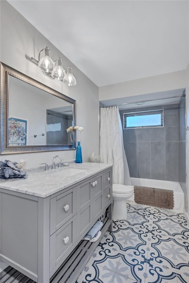 full bathroom with tile patterned floors, shower / tub combo with curtain, vanity, and toilet