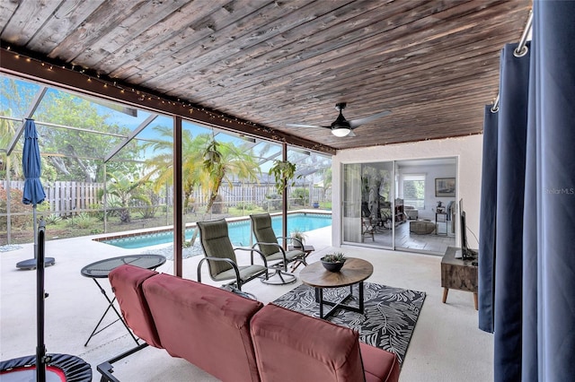 view of patio / terrace featuring a lanai, ceiling fan, and a fenced in pool