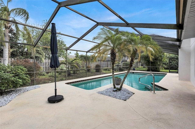 view of pool featuring glass enclosure and a patio