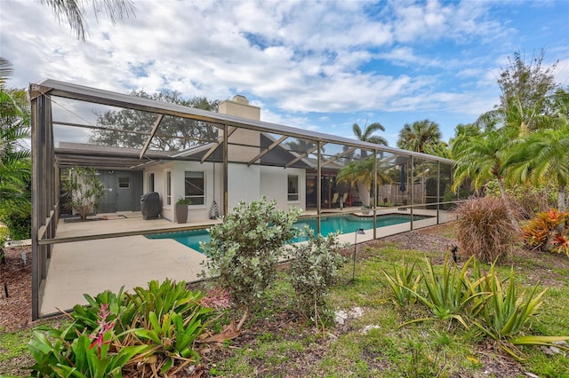 view of pool featuring a patio and glass enclosure