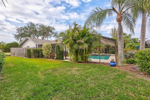 view of yard with a fenced in pool