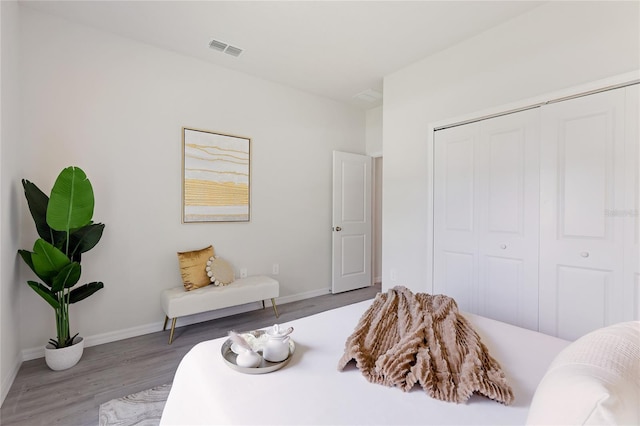 bedroom featuring hardwood / wood-style floors and a closet