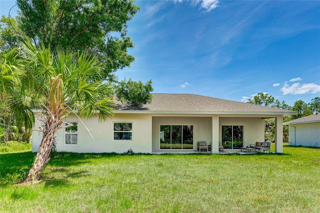 rear view of property with a lawn