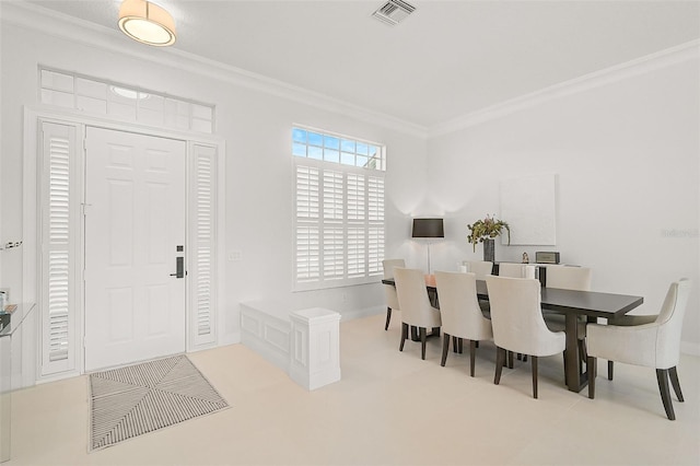 dining space featuring crown molding