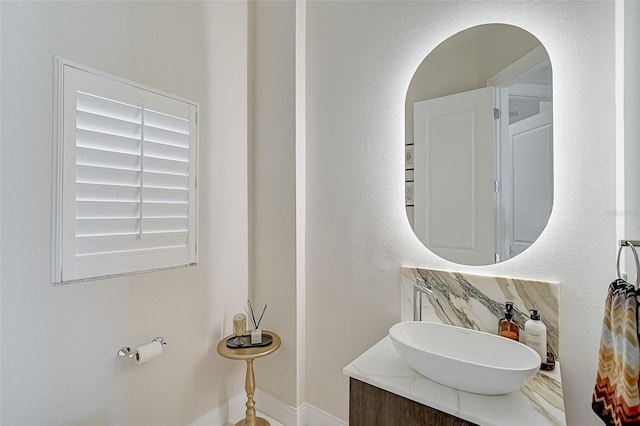 bathroom with vanity and tasteful backsplash