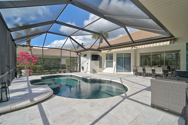 view of swimming pool featuring a lanai, a patio area, and an in ground hot tub