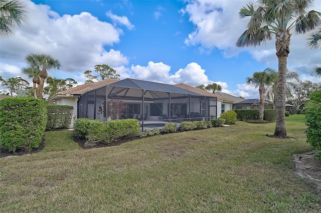 2112 Calusa Lakes Blvd, Nokomis, FL 34275 - back of property featuring a lawn and a lanai