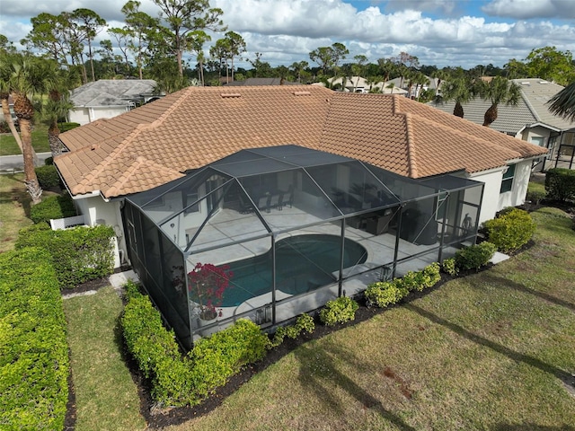 2112 Calusa Lakes Blvd, Nokomis, FL 34275 - view of side of home with a tiled roof, an outdoor pool, a patio, and glass enclosure