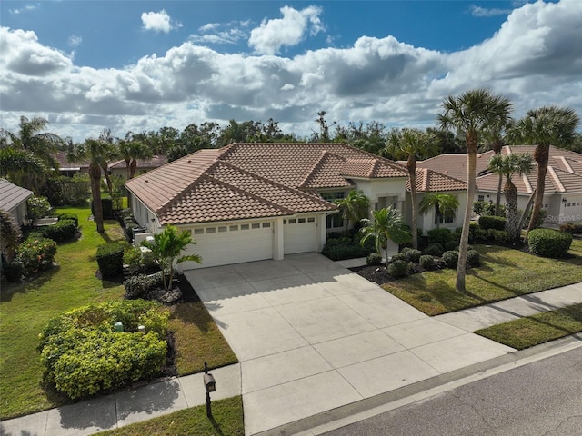 mediterranean / spanish-style home with a garage and a front lawn