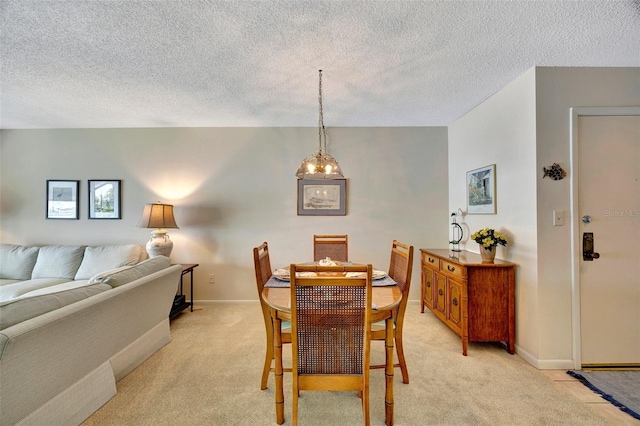 carpeted dining area with a textured ceiling