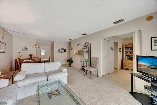 carpeted living room with a textured ceiling