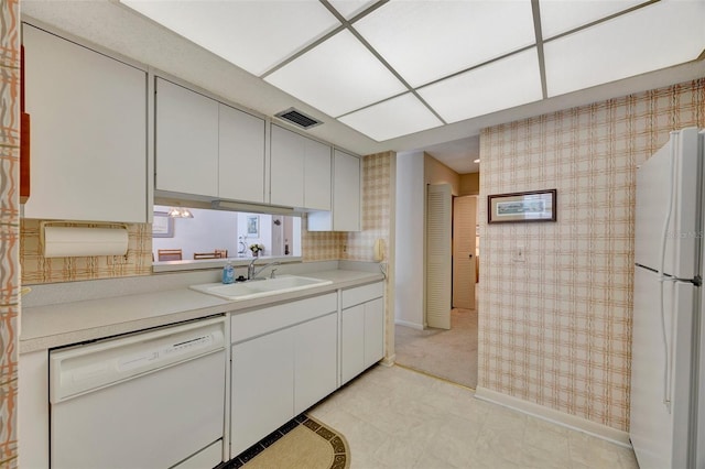 kitchen with white cabinets, white appliances, and sink