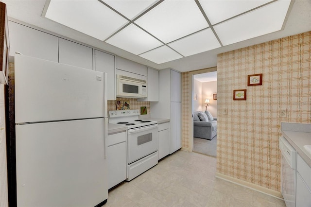 kitchen featuring white cabinetry and white appliances