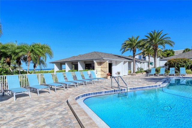 view of swimming pool featuring a patio area and an outdoor structure