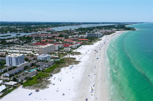 birds eye view of property with a water view and a view of the beach