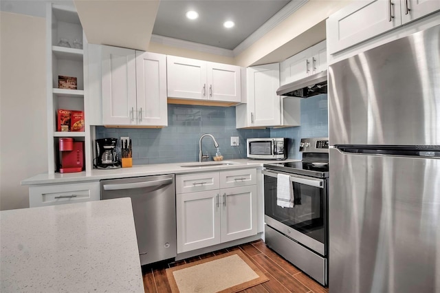 kitchen featuring white cabinets, backsplash, sink, and stainless steel appliances